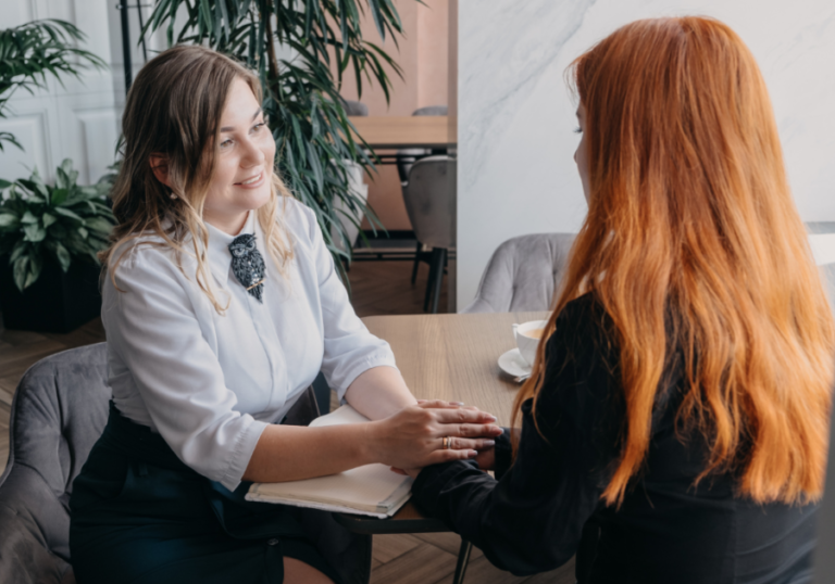 two women sitting facing each other how to validate someone's feelings