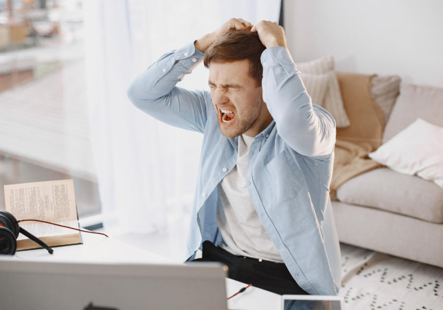 angry man sitting at desk Negative Emotions