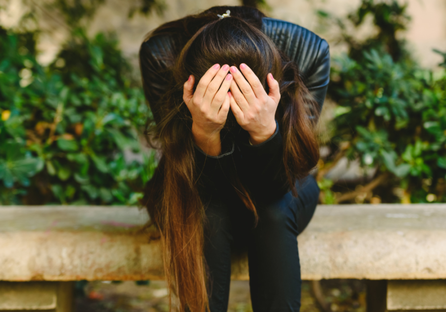 woman hunched over sitting on bench I Cheated on Your Boyfriend