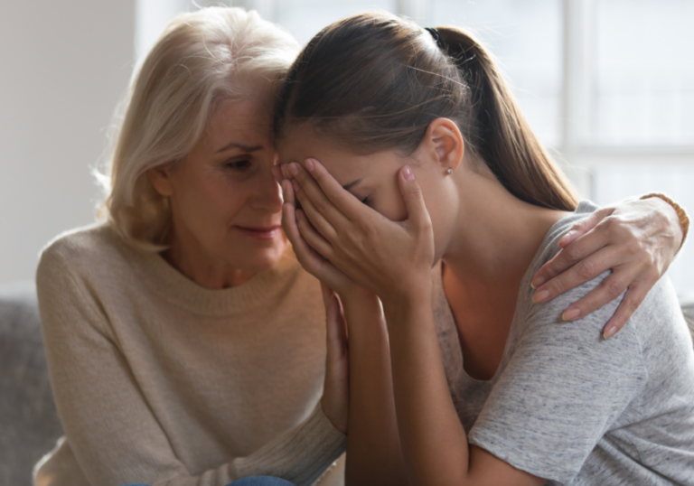 woman hugging younger woman ways to respond when your grown child hurts your feelings