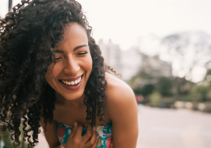 woman laughing at beach high-value woman