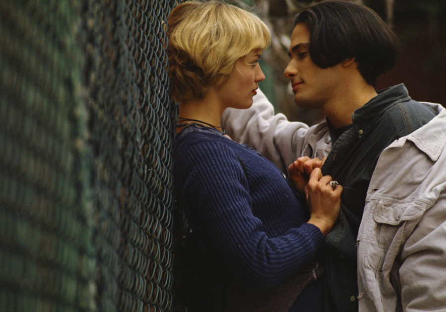 couple standing close near fence signs of a Passionate Relationship