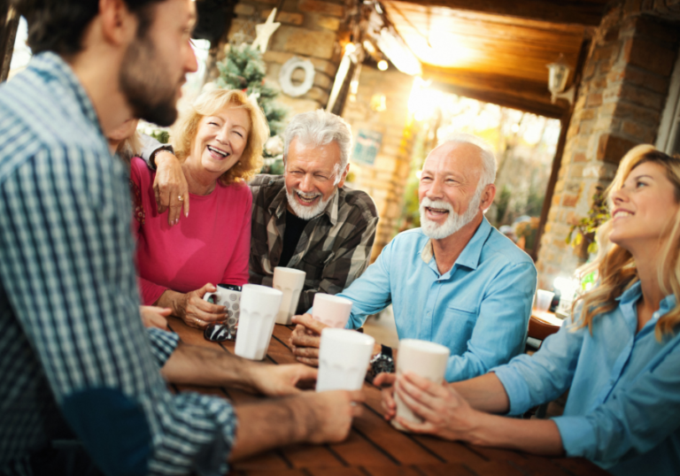 group of people laughing at table questions to ask your family