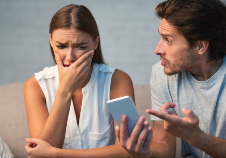 man showing phone to woman is crying Signs Your Wife Is Cheating