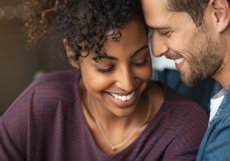 woman and man smiling close together Signs a Capricorn Man Is In Love with You