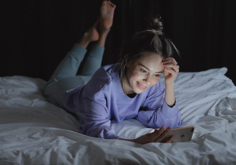 woman lying down looking at phone Goodnight Paragraphs for Her