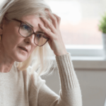 mature woman touching her head supplements for brain fog