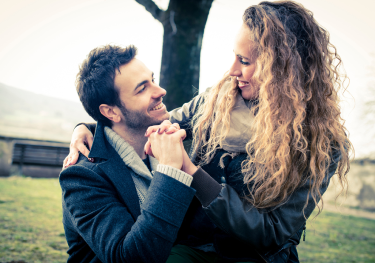 couple holding hand outdoors Signs of an Aries Man in Love