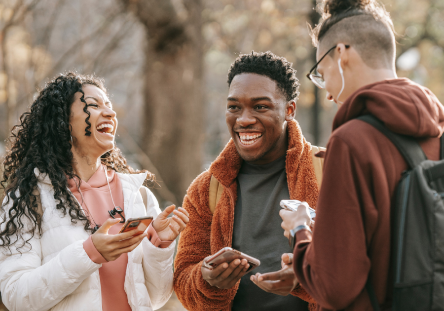 group of young people laughing with phones Funny Ways to Answer the Phone