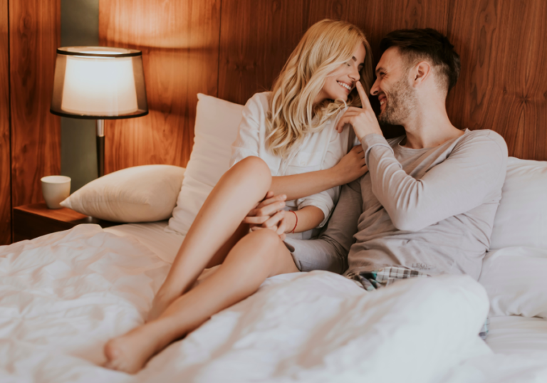 couple sitting in bed laughing Friends With Benefits Rules