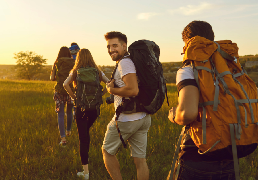 man on hike with friends Leo Man Traits