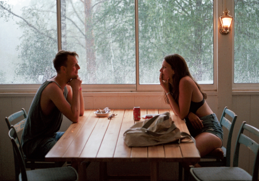 couple sitting at table talking Questions to Ask a Guy