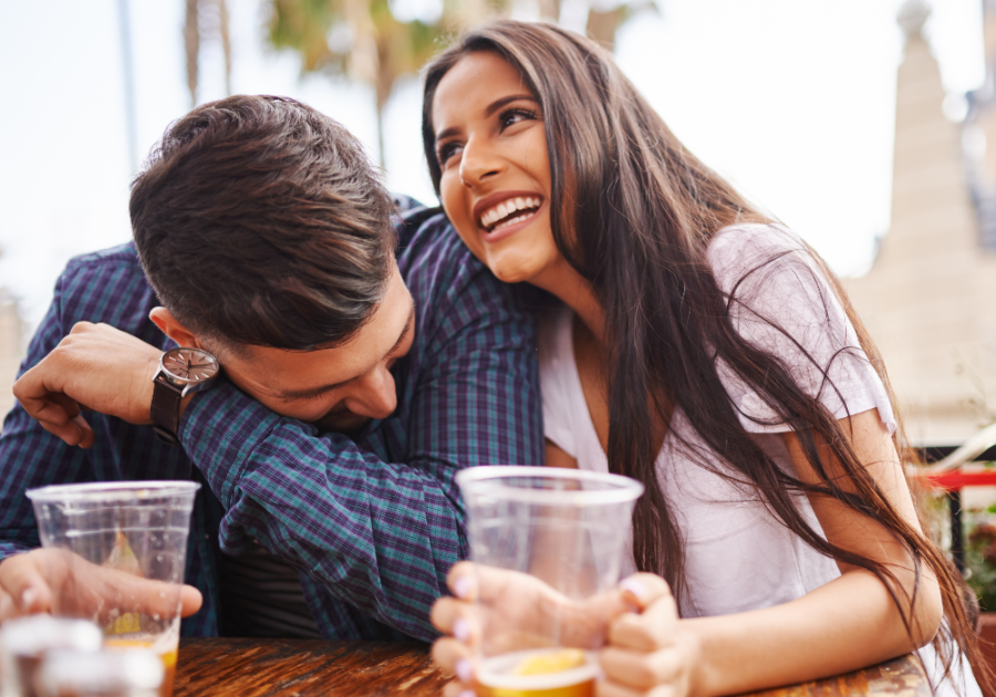 couple laughing drinking beer Weird Questions to Ask a Guy