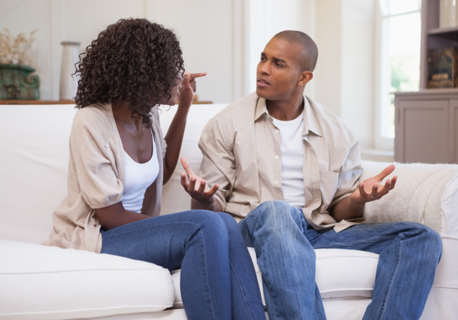 couple on sofa talking with intensity Signs Your Marriage Will End in Divorce