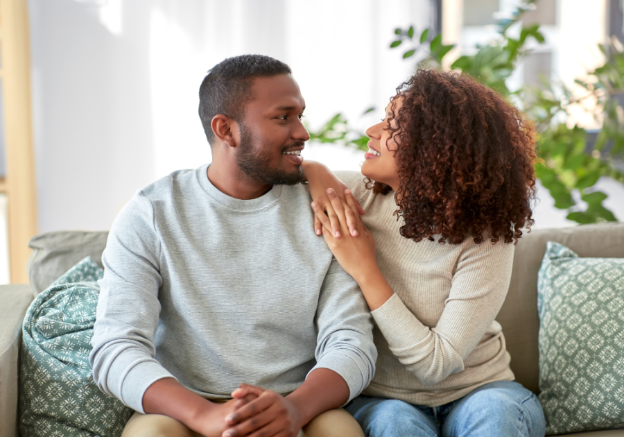 couple sitting on sofa together Questions to Ask a Guy