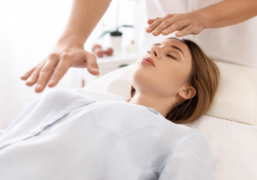 woman receiving a reiki treatment Signs of Blocked Feminine Energy