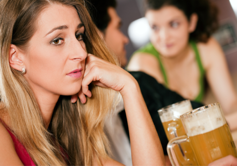 woman drinking beer alone at bar Reasons Guys Don't Like You