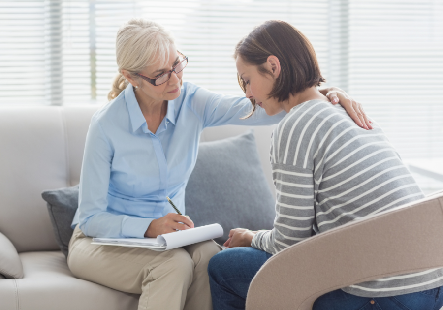 older woman comforting younger woman Signs Your Marriage Is Making You Depressed