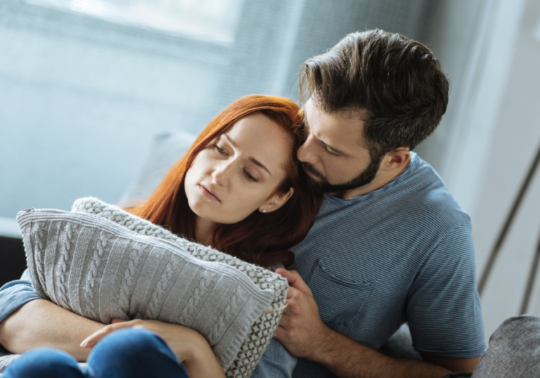 man consoling woman with hug Losing Feelings