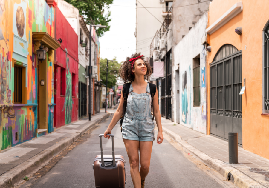 woman strolling with luggage down street Facts About The Aquarius Woman