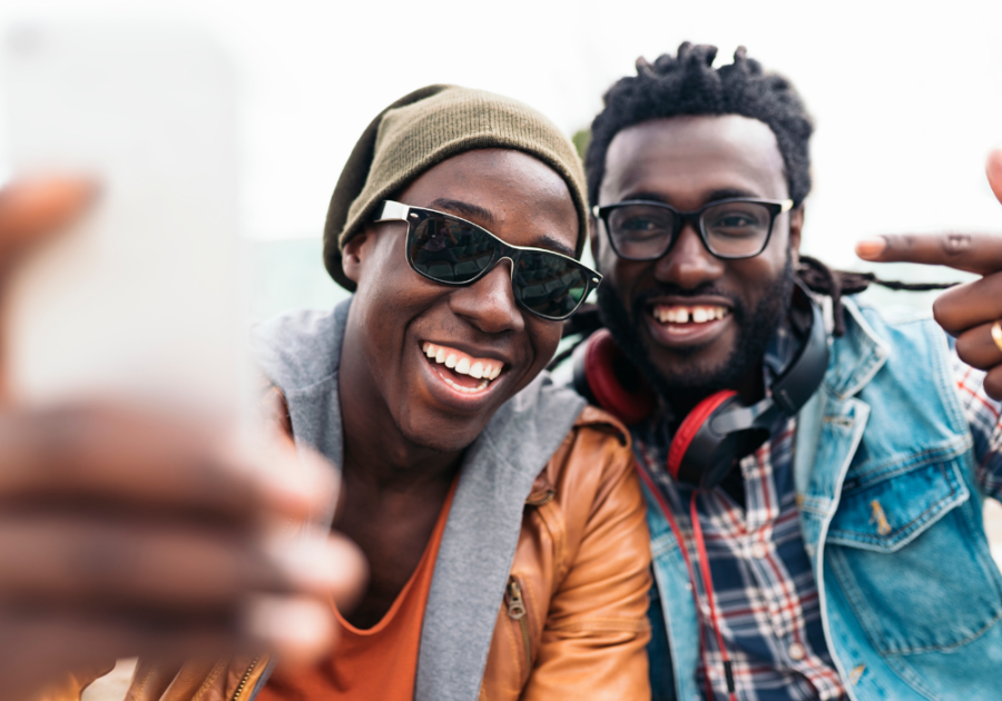 couple taking selfie Leo Man Traits