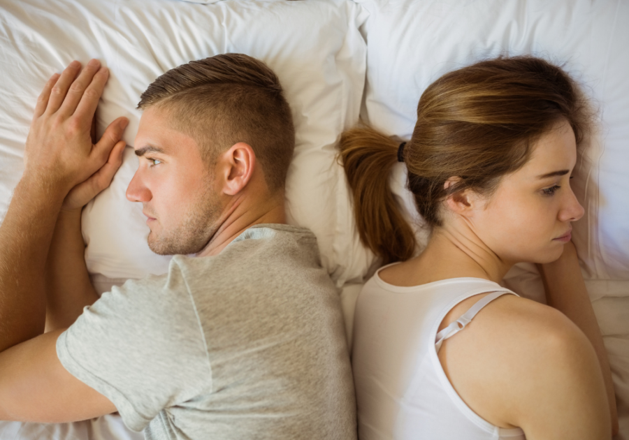 couple laying in bed Signs You Are Forcing a Relationship