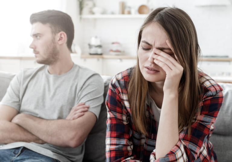 couple on sofa woman crying My Husband Gets Mad At Me When I Tell Him He Hurt My Feelings