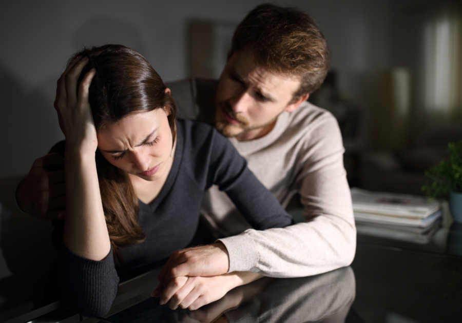 couple sitting close woman is sad Respect Your Wife's Feelings