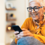 mature woman using her phone woman over 50 dating profile examples