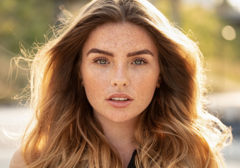 headshot of young woman posing Conventionally Attractive