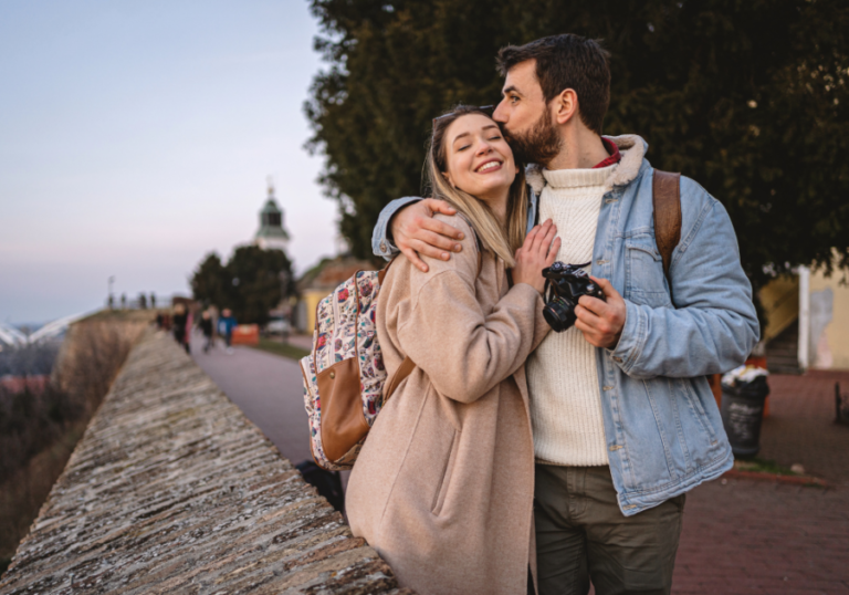 couple walking and man kissing woman on head Reassurance in a Relationship