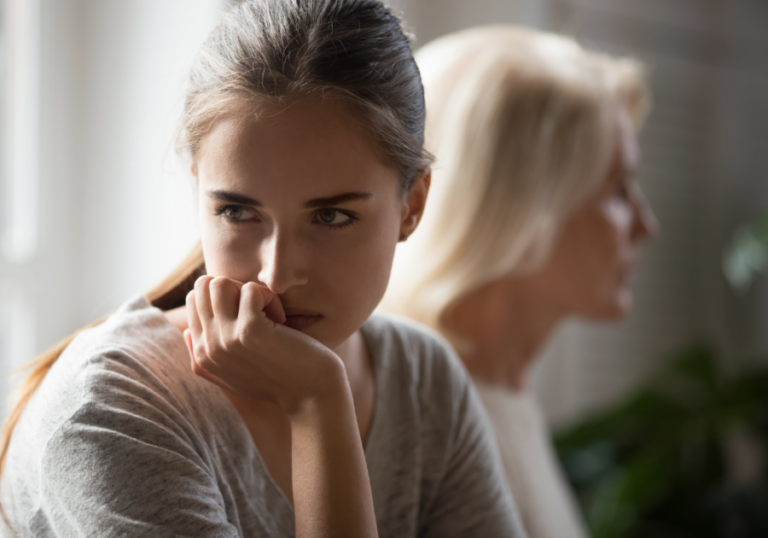 young woman sitting turned away from older woman i hate my mom