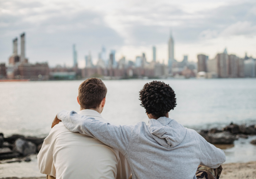 men sitting arm in arm looking at skyline Unexplainable Connection with Someone