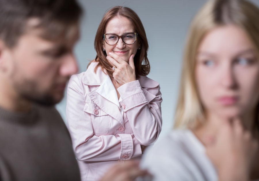 older woman in background smiling at sad couple How to Deal with Family Members That Disrespect You