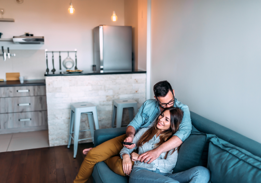 couple snuggling on sofa how to handle a sexually demanding husband