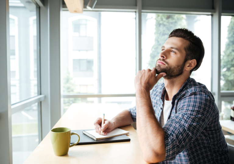 man sitting at desk thinking traits of a stoic personality