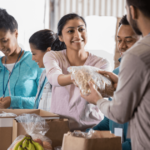 woman handing out food smiling Mindful Pay It Forward Ideas