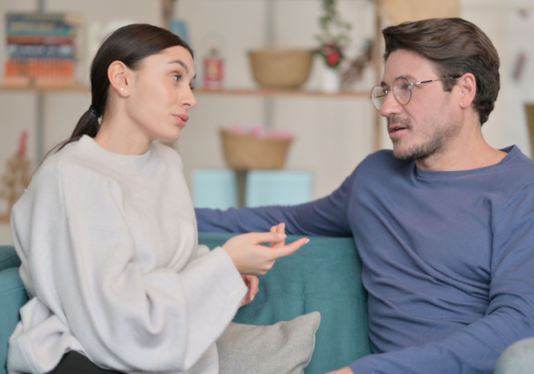 couple talking on sofa Compromise in a Relationship