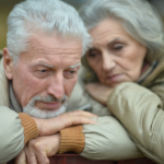 older couple sad leaning on each other How to manage not seeing your grandchildren