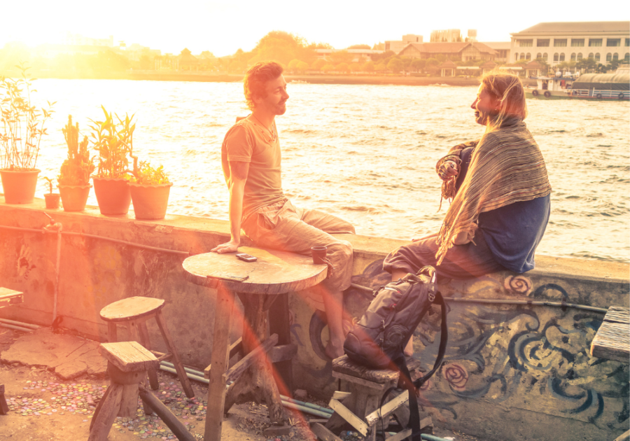 couple sitting by river Keep a Conversation Going with a Girl