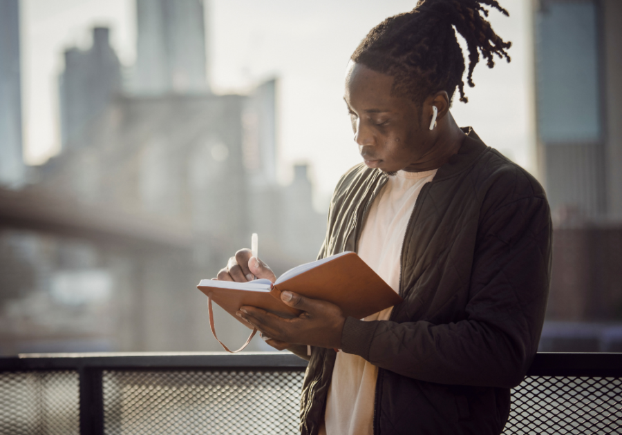 man standing and writing in journal  Love Poems For Crush