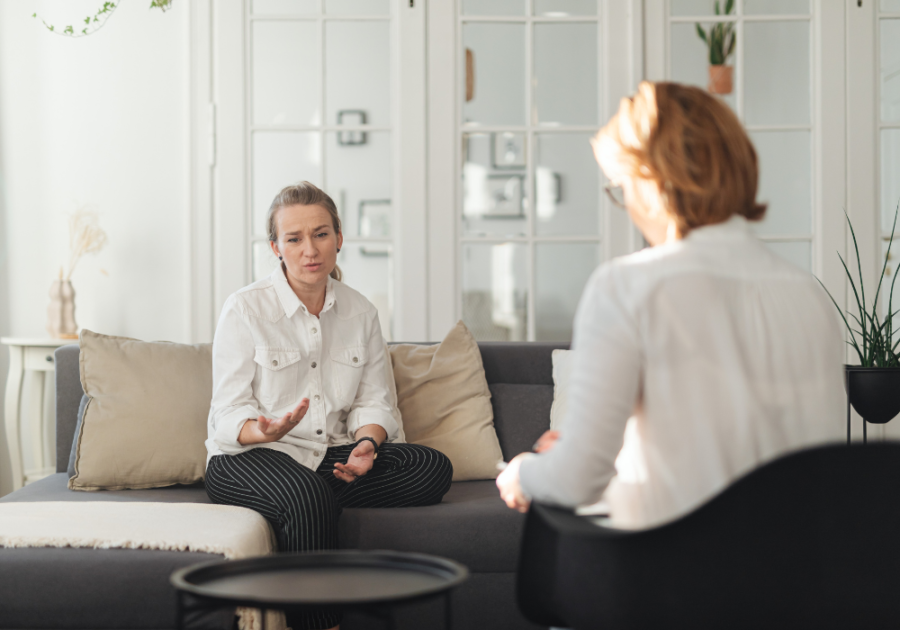 woman sitting across from each other talking feel defeated