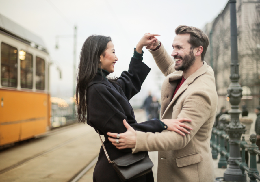 couple smiling and dancing outdoors Aquarius and Virgo Compatibility