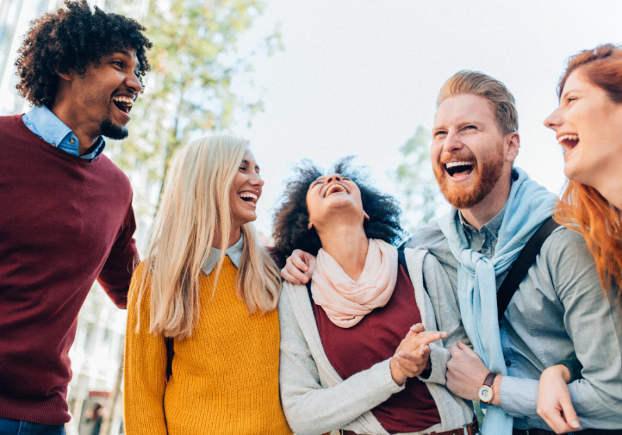 group of friends laughing outdoors Funny Jokes To Tell Your Friends