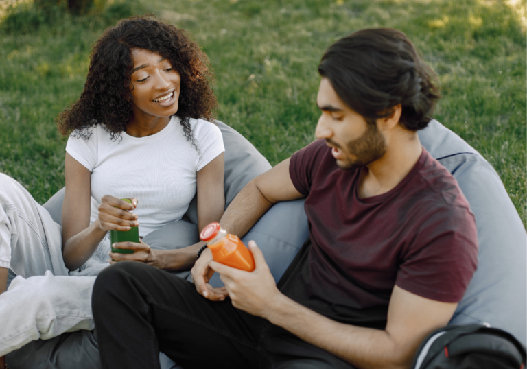 couple sitting outside talking Juicy Questions to Ask Your Boyfriend