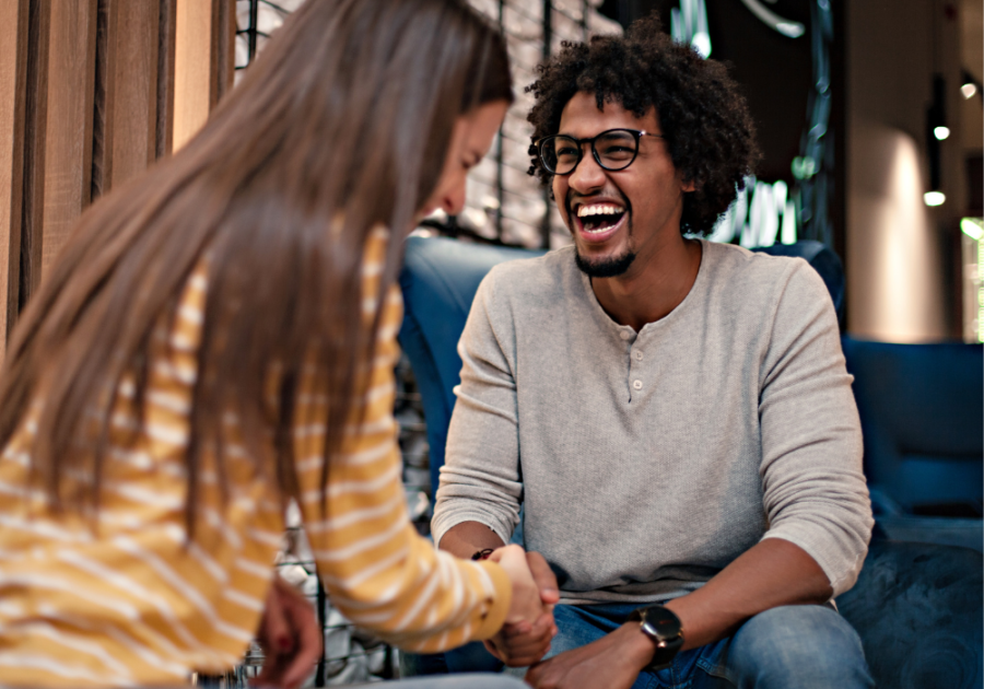 man laughing sitting with woman I Want a Girlfriend