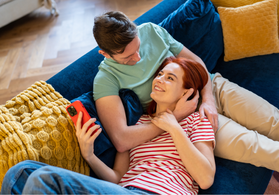 woman laying on mans lap on sofa Juicy Questions to Ask Your Boyfriend