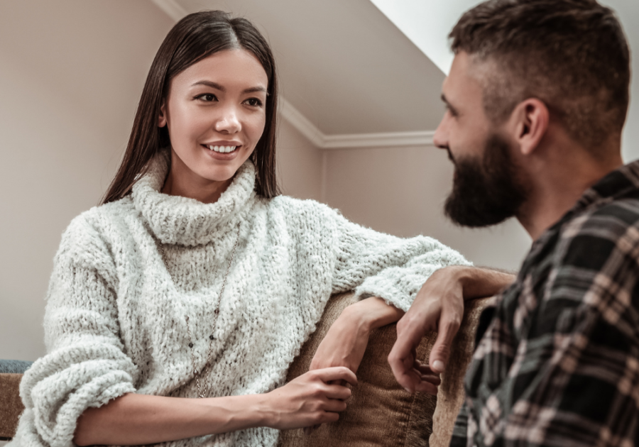 couple sitting on sofa talking When a Guy Tells You Personal Things About Himself