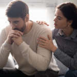 woman sitting by man consoling him a When a Guy Tells You Personal Things About Himself