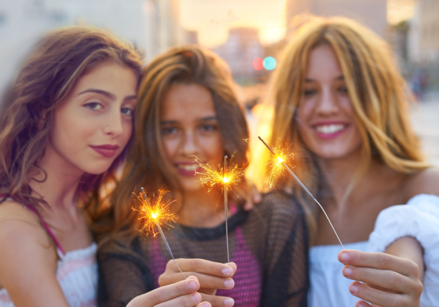 women smiling holding sparklers Make Him Miss You